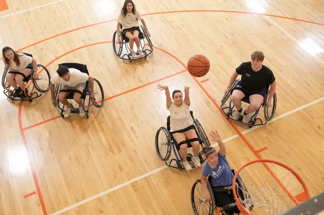 Students playing wheelchair basketball.